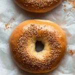 Keto Bagels: The Ultimate Low-Carb Bread Alternative That Tastes Like the Real Thing 5 Close-up of two keto bagels sprinkled with sesame seeds on white parchment
