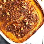 Keto Sweet Potato Casserole: The Best Low-Carb Holiday Side Dish 6 Golden keto sweet potato casserole topped with crunchy pecans in a white baking dish